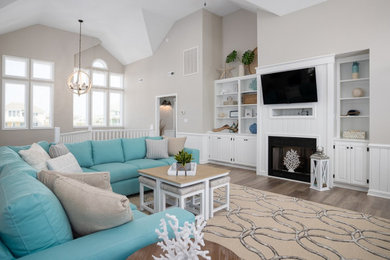 Inspiration for a coastal laminate floor living room remodel in Other with gray walls and a standard fireplace