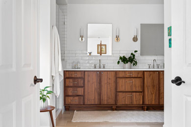Inspiration for a modern master white tile and subway tile porcelain tile, double-sink and brown floor bathroom remodel in Detroit with recessed-panel cabinets, medium tone wood cabinets, white walls, an undermount sink, quartz countertops, white countertops and a built-in vanity