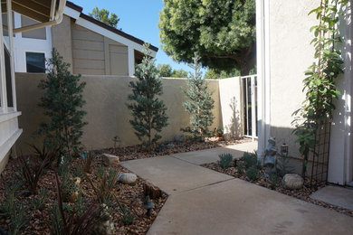 This is an example of a small coastal partial sun front yard landscaping in Orange County.