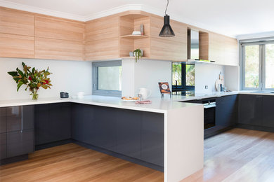Photo of a large scandinavian kitchen in Perth with light wood cabinets, quartz benchtops and light hardwood floors.