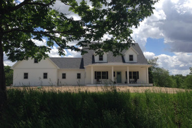 Inspiration for a mid-sized farmhouse white two-story wood exterior home remodel in Other with a shingle roof