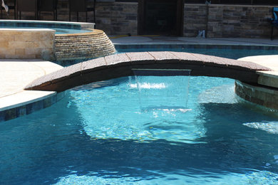 Large mountain style backyard custom-shaped natural pool fountain photo in Houston