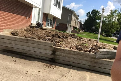 Design ideas for a mid-sized modern full sun front yard retaining wall landscape in Other for summer.