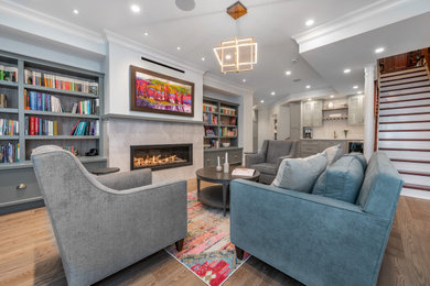 Basement - large modern look-out brown floor basement idea in Ottawa with gray walls and a tile fireplace