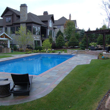 Bluestone pool decks, arbors, fireplaces, outdoor kitchen under pavilion