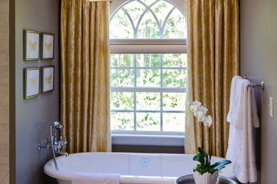 Example of a mid-sized classic 3/4 marble floor freestanding bathtub design in Richmond with gray walls