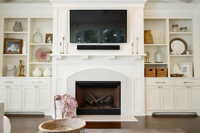 Inspiration for a large eclectic open concept dark wood floor and brown floor living room remodel in Charleston with white walls, a standard fireplace and a tile fireplace