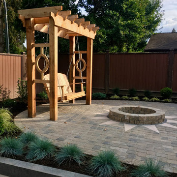 Custom pergola with swinging bench and firepit