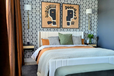 Example of a minimalist master light wood floor, beige floor, tray ceiling and wallpaper bedroom design in Atlanta with black walls