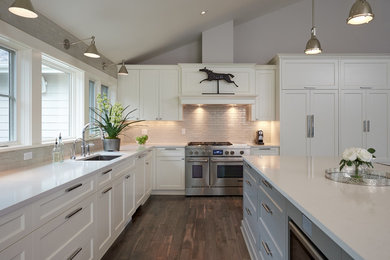 Example of a large trendy l-shaped medium tone wood floor eat-in kitchen design in Portland with an undermount sink, recessed-panel cabinets, white cabinets, quartzite countertops, gray backsplash, subway tile backsplash, paneled appliances and an island
