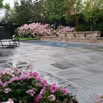 Pool, waterfall, and landscaping