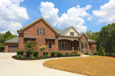 Mid-sized arts and crafts one-story brick gable roof photo in Nashville