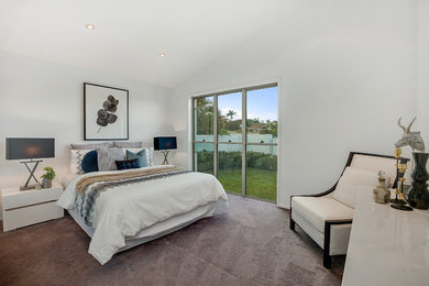 Mid-sized contemporary guest bedroom in Gold Coast - Tweed with white walls, carpet and grey floor.