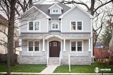 Example of a large classic gray two-story concrete fiberboard exterior home design in Chicago with a mixed material roof