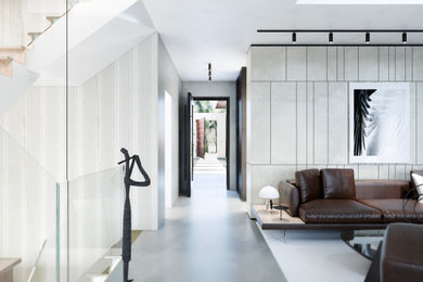 Esempio di un grande ingresso design con pareti grigie, pavimento in cemento, una porta singola, una porta in legno scuro, pavimento grigio, soffitto ribassato e pannellatura