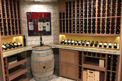Wine cellar - mid-sized rustic porcelain tile wine cellar idea in Calgary