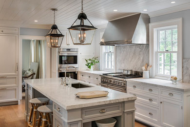 Design ideas for a large country u-shaped separate kitchen in New York with an undermount sink, white cabinets, marble benchtops, grey splashback, stainless steel appliances, light hardwood floors, with island, marble splashback, brown floor and recessed-panel cabinets.