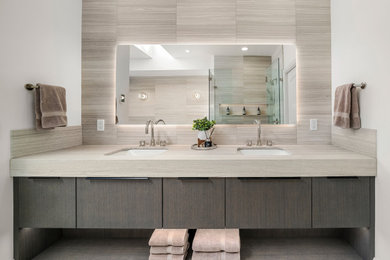 Bathroom - huge contemporary master gray tile and ceramic tile ceramic tile, gray floor and double-sink bathroom idea in Calgary with flat-panel cabinets, gray cabinets, gray walls, an undermount sink, marble countertops, a hinged shower door, gray countertops and a built-in vanity