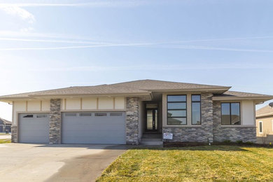 Mid-sized transitional beige two-story mixed siding exterior home photo in Other with a hip roof