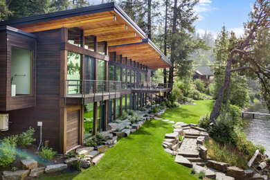 Large contemporary multicolored two-story mixed siding exterior home idea in Other with a green roof
