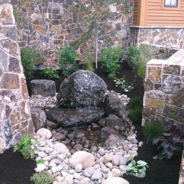 Bubbling boulder pondless water features