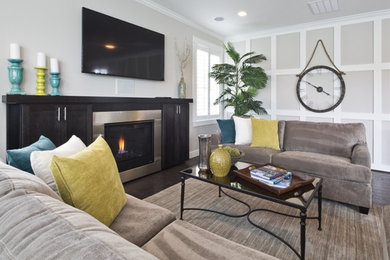 Inspiration for a mid-sized contemporary open concept medium tone wood floor living room remodel in Seattle with gray walls, a standard fireplace, a metal fireplace and a wall-mounted tv