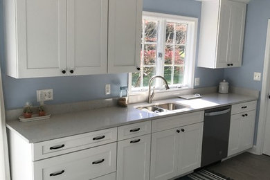Mid-sized transitional porcelain tile and gray floor eat-in kitchen photo in Other with a double-bowl sink, shaker cabinets, white cabinets, quartz countertops, stainless steel appliances, no island and gray countertops