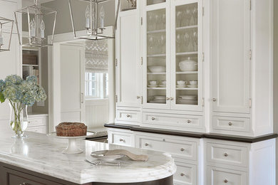 Inspiration for a mid-sized transitional kitchen in St Louis with beaded inset cabinets, white cabinets, marble benchtops, panelled appliances, medium hardwood floors and with island.