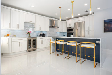 Example of a large trendy l-shaped porcelain tile and white floor eat-in kitchen design in Miami with a single-bowl sink, shaker cabinets, blue cabinets, quartzite countertops, white backsplash, marble backsplash, stainless steel appliances, an island and white countertops