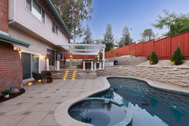 Backyard concrete paver pool landscaping photo in San Francisco