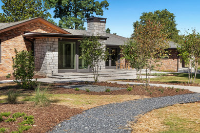 Inspiration for a large transitional brown one-story mixed siding exterior home remodel in Atlanta with a tile roof and a gray roof