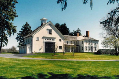 Large elegant white two-story wood gable roof photo in Boston