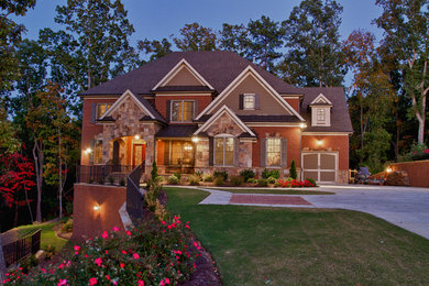 Design ideas for a mid-sized traditional two-storey brick red exterior in Atlanta with a hip roof.