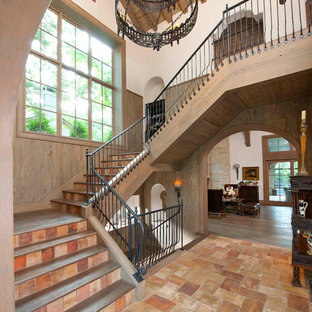 Design ideas for a mediterranean wood metal railing staircase in Dallas with terracotta risers.