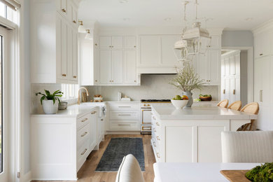 Large transitional l-shaped light wood floor and brown floor eat-in kitchen photo in Minneapolis with a farmhouse sink, beaded inset cabinets, white cabinets, quartzite countertops, white backsplash, quartz backsplash, paneled appliances, an island and white countertops