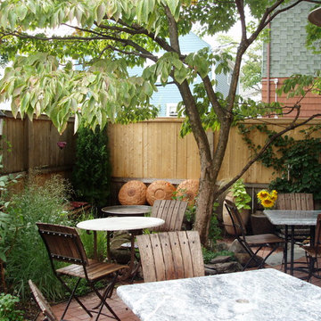 Dogwood, vines, evergreens, and grasses enclosing waiting and dining areas on th