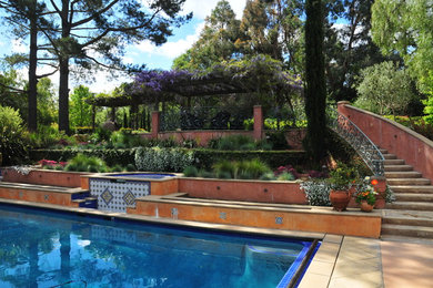This is an example of a large mediterranean backyard rectangular pool in San Francisco with stamped concrete.