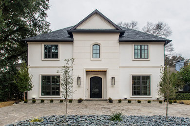 Transitional beige two-story house exterior idea in Dallas with a hip roof and a shingle roof