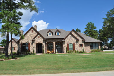 Photo of a mid-sized transitional one-storey beige exterior in Houston with mixed siding and a gable roof.