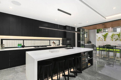 Inspiration for a modern kitchen with black cabinets and white benchtop.