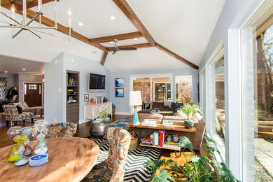 Family room - large transitional open concept medium tone wood floor and brown floor family room idea in Dallas with gray walls