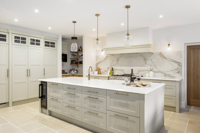 Inspiration for a classic open plan kitchen in Other with a belfast sink, shaker cabinets, quartz worktops, multi-coloured splashback, stone slab splashback, integrated appliances, an island and white worktops.