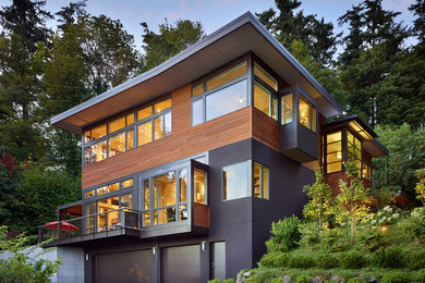 Mid-sized modern gray three-story mixed siding exterior home idea in Seattle with a shed roof