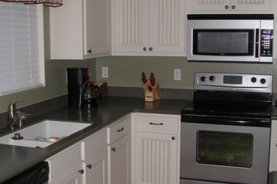 Inspiration for a mid-sized timeless kitchen remodel in Other with white cabinets and stainless steel appliances