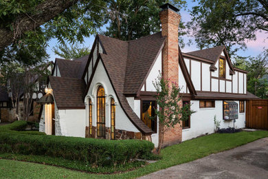 Large arts and crafts white two-story mixed siding exterior home photo in Dallas with a shingle roof and a brown roof