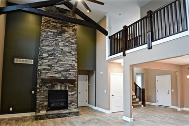 Inspiration for a large craftsman open concept laminate floor family room remodel in Other with green walls, a standard fireplace and a stone fireplace