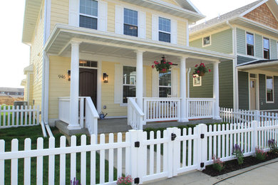 Example of a mid-sized classic yellow two-story wood exterior home design in Cedar Rapids