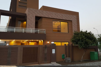 Example of a mid-sized tuscan two-story brick exterior home design in Other with a mixed material roof