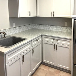 Photo of a medium sized country l-shaped separated utility room in Portland with a single-bowl sink, beaded cabinets, grey cabinets, granite worktops, grey walls, ceramic flooring, a side by side washer and dryer, pink floors and white worktops.