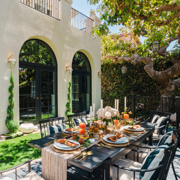 Mediterranean Patio Dining Area with Arched French Doors and Elegant Tablescape
